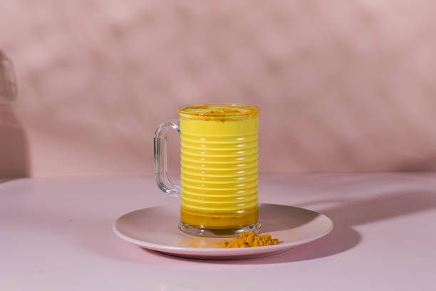 istock Latte turmeric on a pink background with hard shadows. Moon milk for better sleep. Copy space. 1352589952