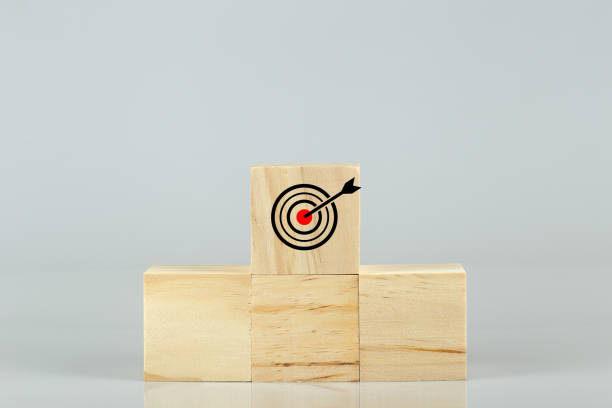 istock Podium wooden blocks ranking on table white background, goal objective destination. 1352591759