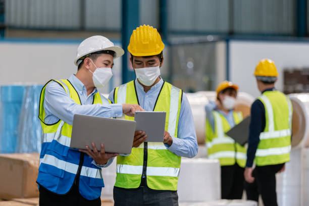 istock Teamwork engineer in uniform wear protection mask brainstorming workshop industrial factory building. meeting worker team. 1352591940