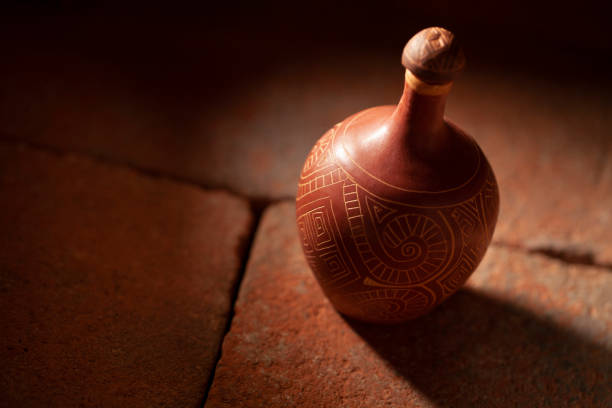 Handmade terracotta jug on an old terracotta floor. Handicraft products of Indigenous tribes in Brazil.