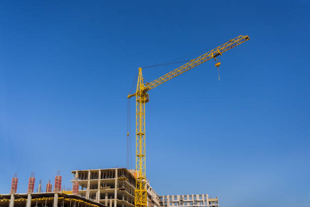 istock High rise building under construction at construction tower cranes 1352595548