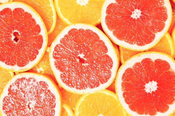 istock Slices of oranges and a grapefruits as a background. 1352598189
