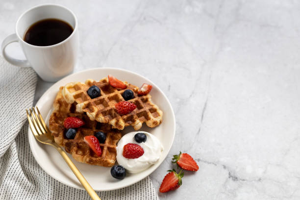 istock Delicious breakfast with croffles (Croissant waffle) served with whipped cream and berries. 1352598928