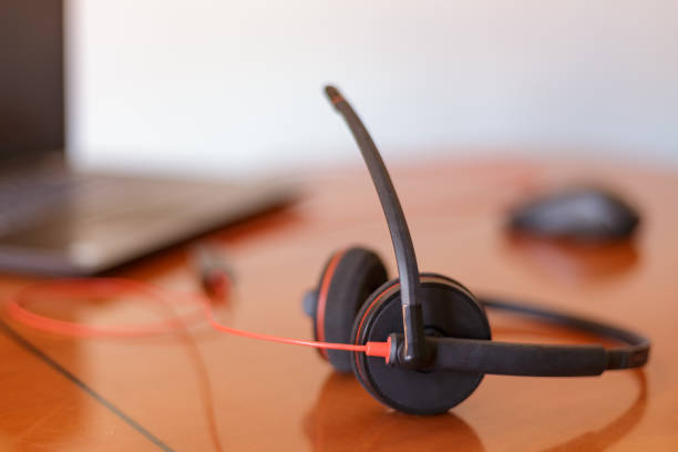 istock Headphones with microphone and laptop on work table. Telecommuting. Working at home. Madrid, Spain 1352599341