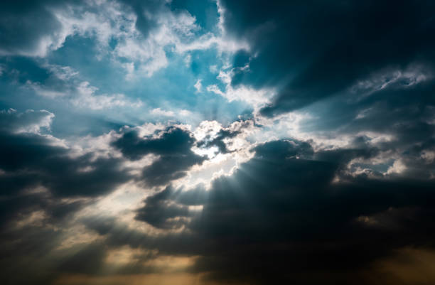 istock God light. Dark cloudy sky with sun beam. Sun rays through black clouds. God light from heaven for hope and faithful concept. Believe in god. Heaven sky. Overcast sky. Spiritual religious background. 1352599350
