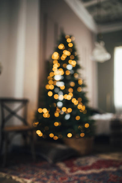 istock Blurred defocused Christmas tree in cozy room. 1352600158