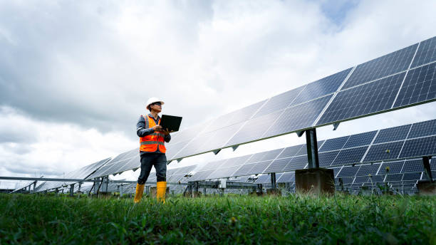 The solar farm(solar panel) with engineers check the operation of the system, Alternative energy to conserve the world's energy, Photovoltaic module idea for clean energy production stock photo