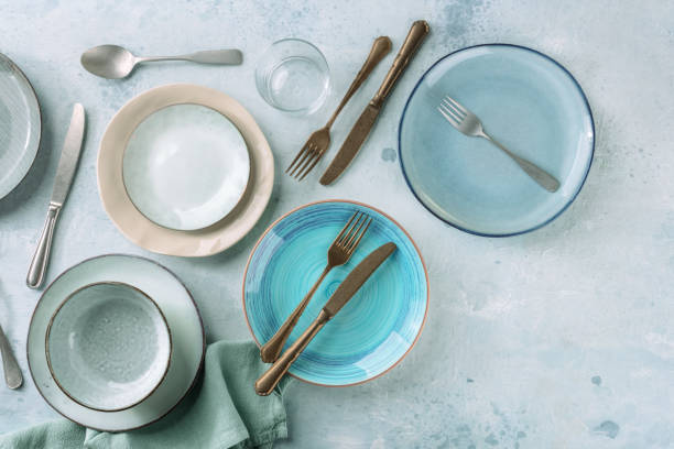 istock Modern tableware set with cutlery and a vibrant blue plate, overhead flat lay 1352601481