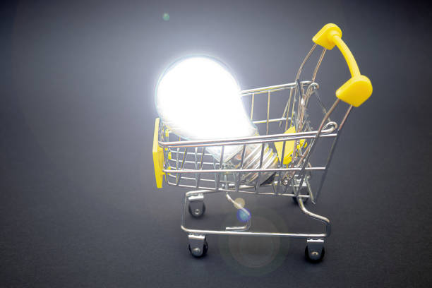 istock Energy saving lightbulb in a small shopping cart 1352602302