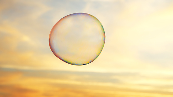 Soap bubble against clouds at sunset.