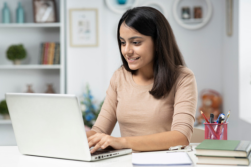 Young woman working at home, stock photo