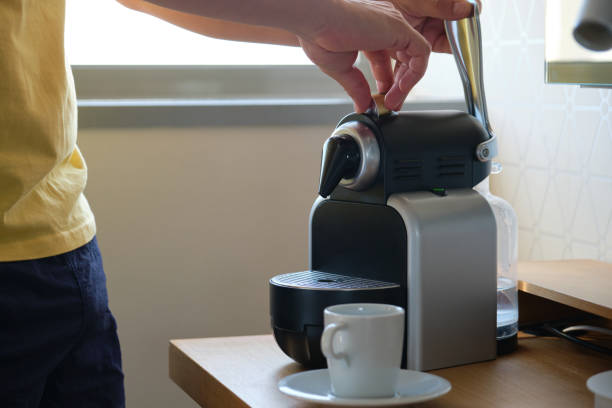 istock Unrecognizable man preparing coffee in a coffee machine with capsules. 1352608169