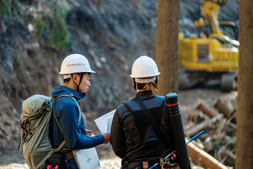 Selective Logging Map Two Forestry Workers Review A Topographic Map At A Selective Logging ...