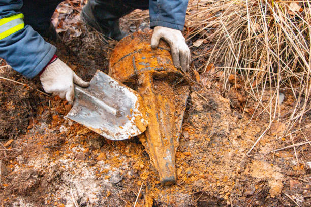 istock Man hands keep old iron fragments, clean them from dirt, clay, land and rust, after searching and producing scrap metal in forest. 1352613846