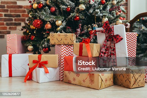 istock Multicolored gifts under the Christmas tree photo close-up New Year's Eve, multicolored gifts, red and gray and black 1352620877