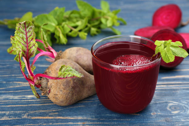istock Freshly made beet juice on blue wooden table 1352620947