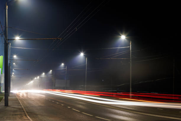 istock empty foggy night road with rows of lamp posts 1352622717