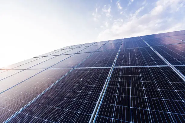 Solar panel photo close up on blue sky background, renewable energy eco