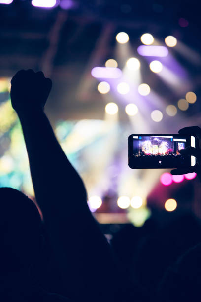 istock Person holding modern smartphone on a concert. 1352623600