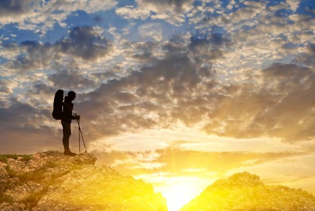 istock tourist on a mountain top at the sunset 1352623634