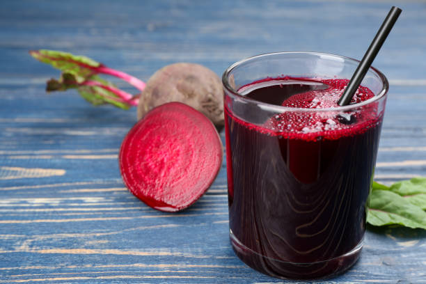 istock Freshly made beet juice on blue wooden table 1352623943