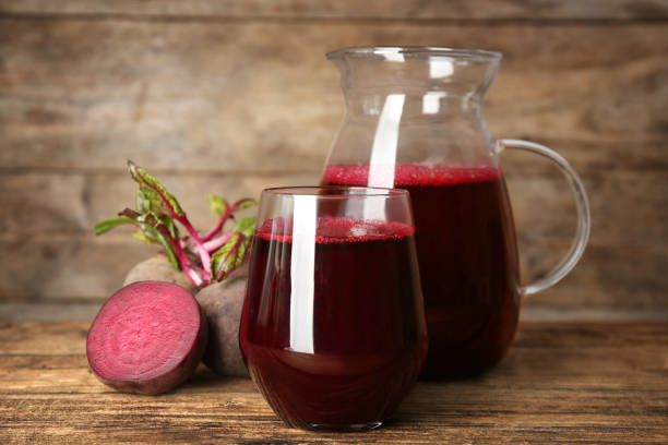 istock Freshly made beet juice on wooden table 1352629716