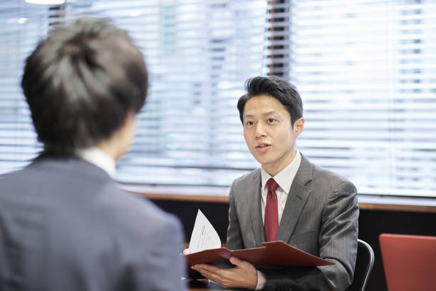 Asian managerial business person interviewing Asian managerial business person interviewing japanese ethnicity stock pictures, royalty-free photos & images