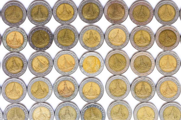 istock Ten baht coins in a row on white background. 1352642956