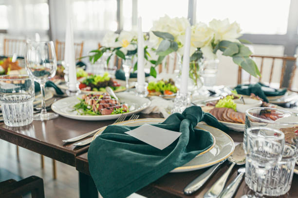istock Festive wedding table decorated with green napkins and candles 1352643180