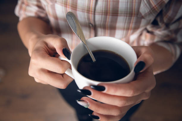 istock woman holding cup of coffee 1352643317