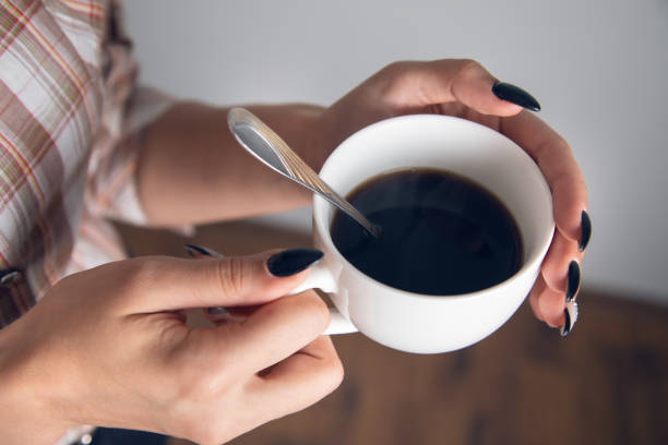 istock woman holding cup of coffee 1352643322
