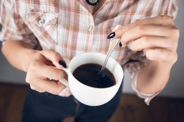 istock woman holding cup of coffee 1352643325