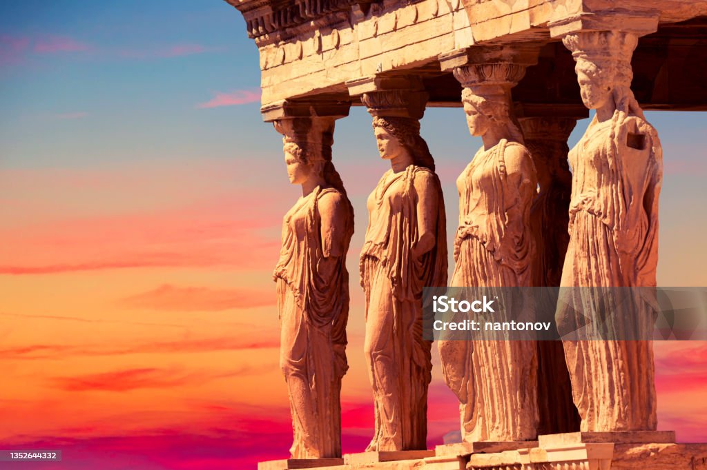 Detail of Caryatid Porch on the Acropolis uring colorful sunset in Athens, Greece. Ancient Erechtheion or Erechtheum temple. World famous landmark at the Acropolis Hill. Detail of Caryatid Porch on the Acropolis uring colorful sunset in Athens, Greece. Ancient Erechtheion or Erechtheum temple. World famous landmark at the Acropolis Hill Athens - Greece Stock Photo