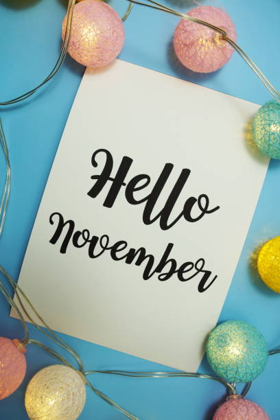 istock Hello November typography text with LED cotton ball on blue background 1352644818