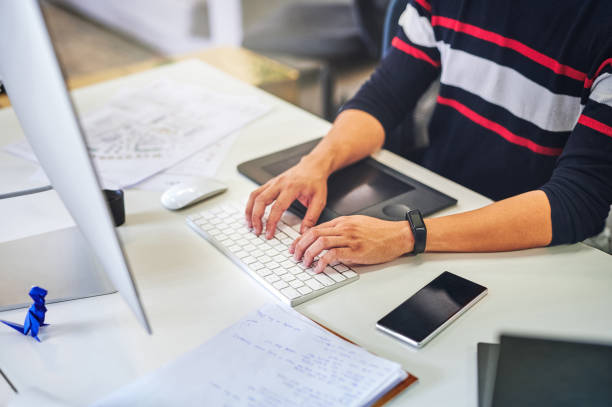 istock Shot of a businessman working at his desk using his computer 1352646079