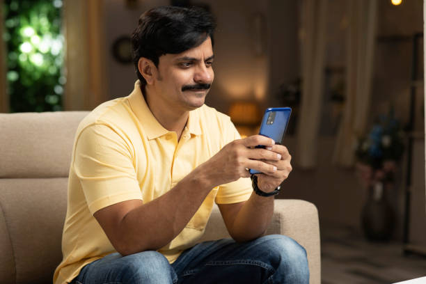 istock Mid adult man using smartphone stock photo 1352646527