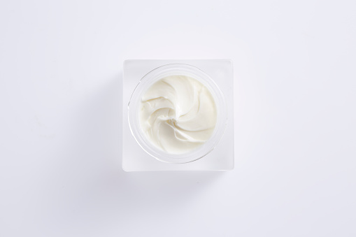 Top view of cosmetic cream product on white background