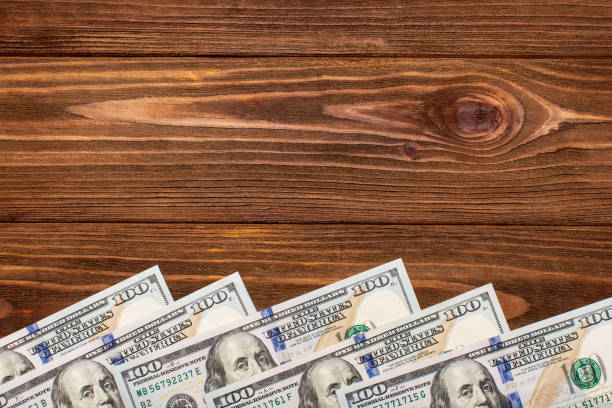 istock Hundred dollar bills background, top view, copy space 1352648707