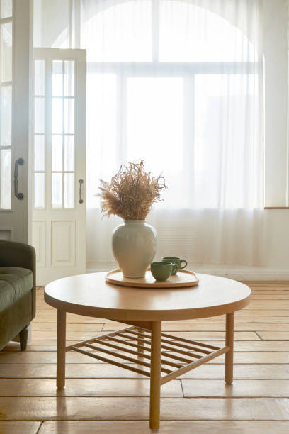 istock Vase with flowers on table in room 1352649242