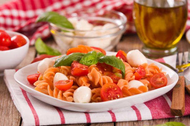 Fusilli pasta with cherry tomatoes and mozzarella cheese.