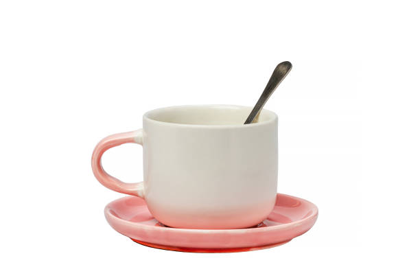 istock White-pink tea pair with a spoon on a white isolated background. Kitchenware. 1352651175