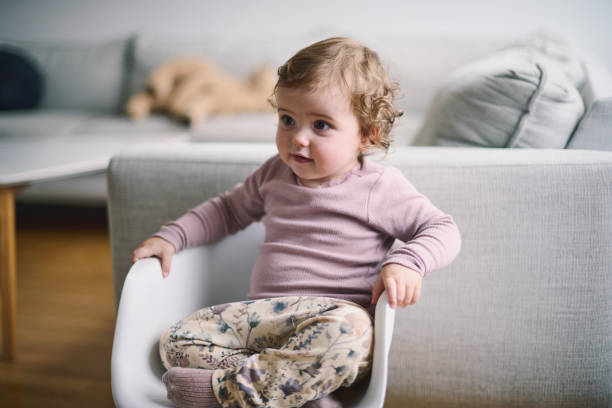 istock small girl sitting in chair 1352652088