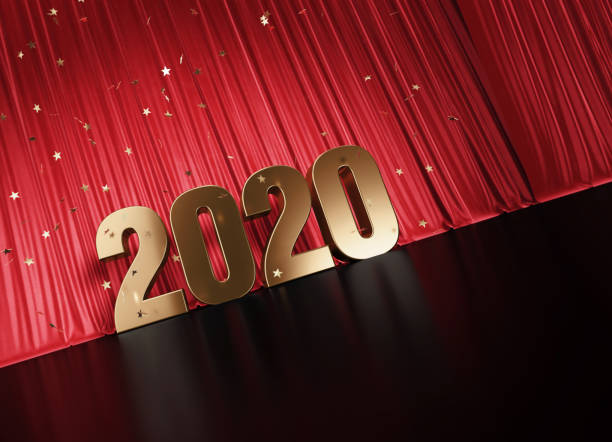istock 2020 Concept - Gold Colored 2020 Sitting Before Red Curtain Under Star Shaped Confetti 1352652266