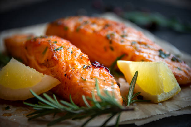 istock Cooked salmon fish fillet with lemon and rosemary 1352652893