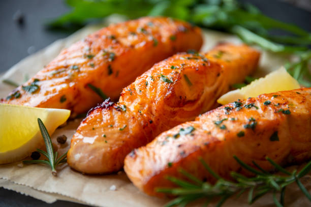 istock Cooked salmon fish fillet with lemon and rosemary 1352653275