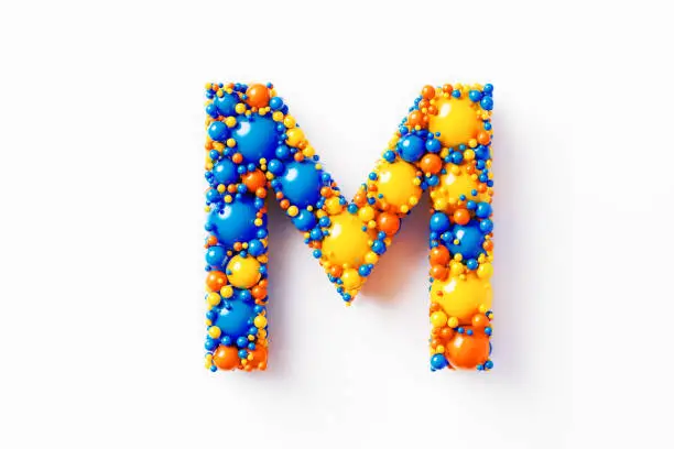 Colorful capital letter M made of many spheres sitting on white background. Horizontal composition with clipping path and copy space. Directly above.