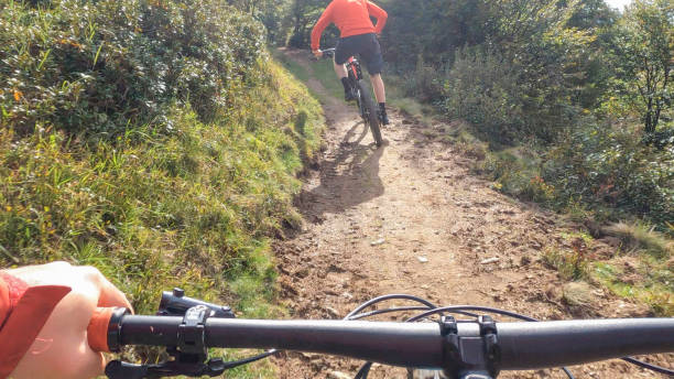 istock POV past handlebars following a mountain biker along high meadow 1352653659