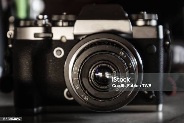 Close Up View Of A Vintage Old 50mm Ussr Lens On A Silver And Black Hybrid Camera Body On A Grey Desk Top Stock Photo - Download Image Now