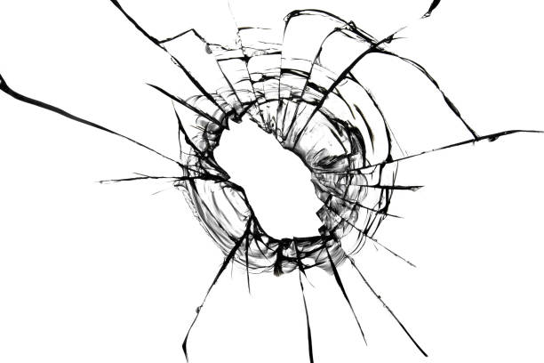 istock Cracks from a bullet in the glass. Broken glass shot. Abstract texture on white background. 1352654633
