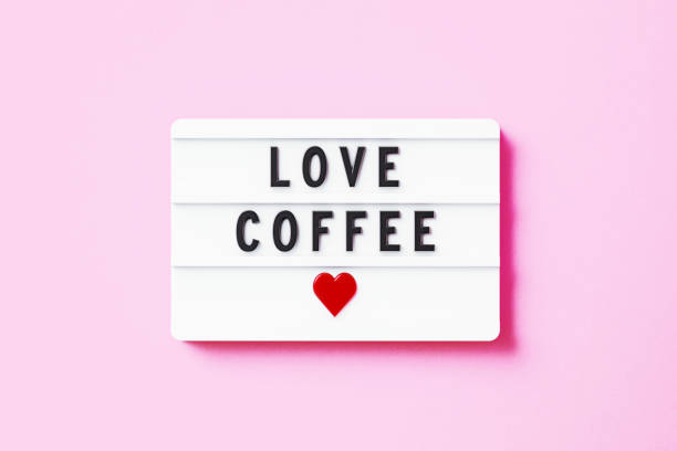 istock Love Coffee Written White Lightbox Sitting On Pink Background 1352654747